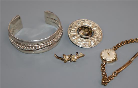 A Scottish silver and citrine brooch, a white metal bangle and a Tissot wrist watch and a 9ct gold brooch.